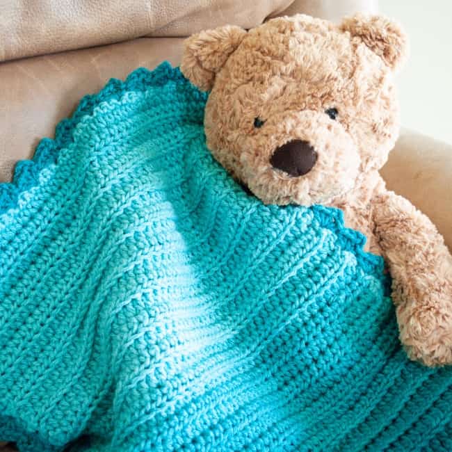 teddy bear holding ombre yarn crochet security blanket