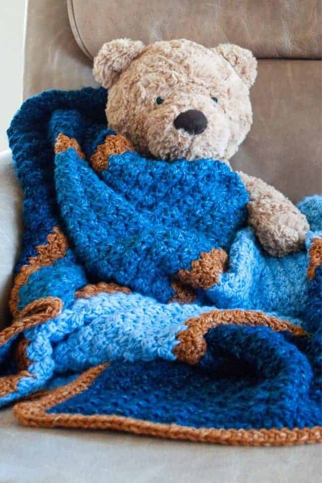teddy bear and blue crochet baby blanket
