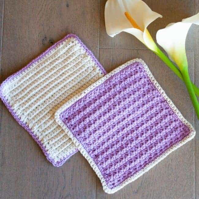 purple and cream crocheted washcloths with flower