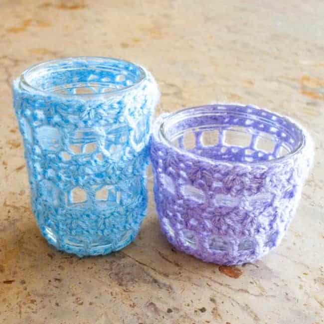 light blue and purple crochet mason jar covers over empty jars