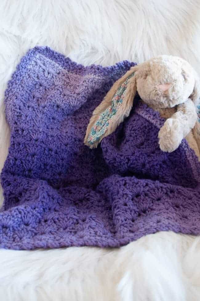 stuffed bunny and purple ombre yarn crochet baby blanket