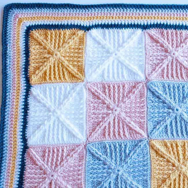 close up of corner portion of crochet squares baby blanket