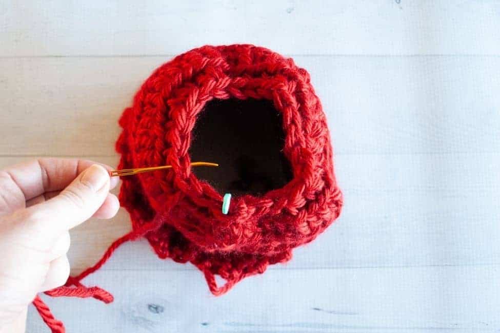 top of crochet hat with tapestry needle