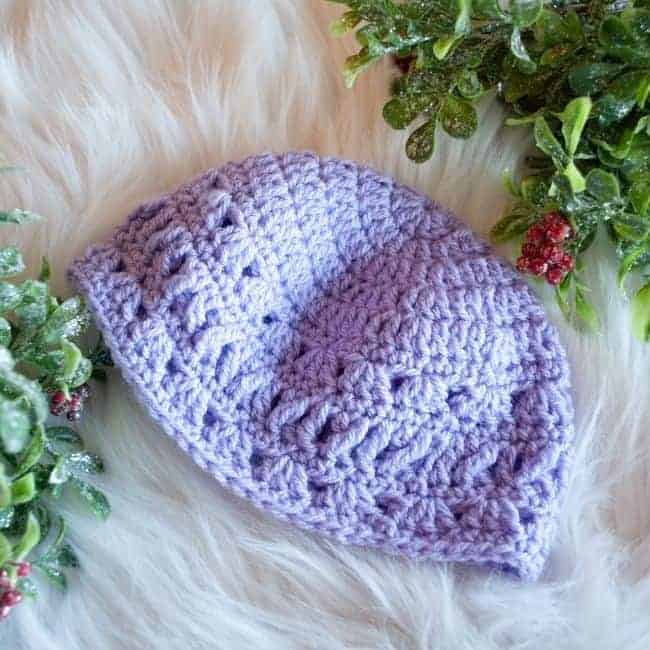 purple lace crochet baby hat with greenery