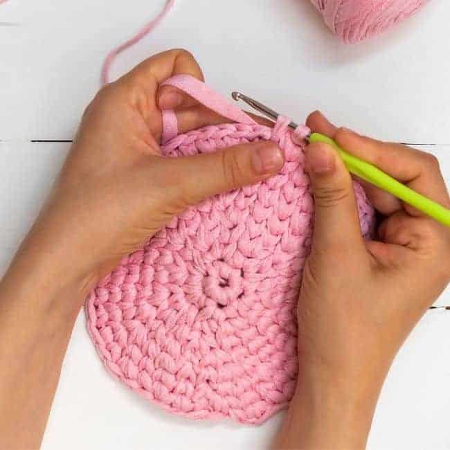 close up of working crochet stitches one at a time