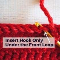close up of inserting the hook under the front loop only with text labeling the technique