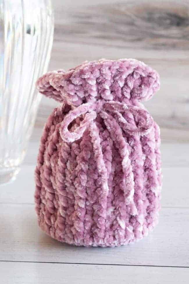velvet yarn crochet gift bag with vase in the background