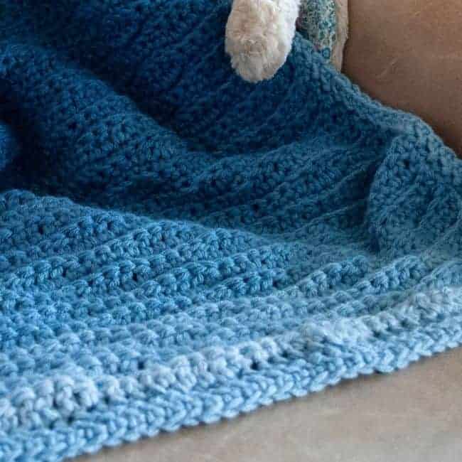 close up of edge of blue crochet blanket