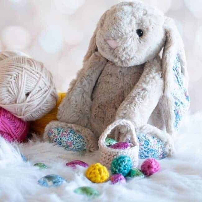 stuffed easter bunny with balls of yarn and mini crochet easter eggs and basket plus chocolate eggs