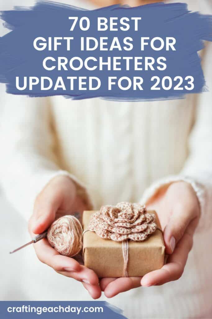 close up of hands holding gift, yarn, and crochet hook and text reading 70 best gift ideas for crocheters updated for 2023
