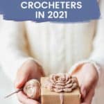 hands holding gift and crochet hook with text reading 70 best gifts for crocheters in 2021