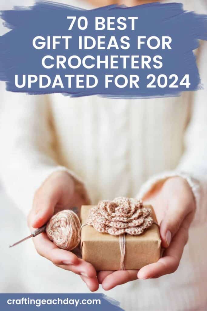 hands holding a gift wrapped in a crochet flower and text reading 70 best gift ideas for crocheters updated for 2024