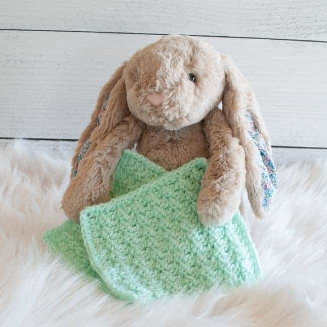 stuffed bunny holding two bonding squares