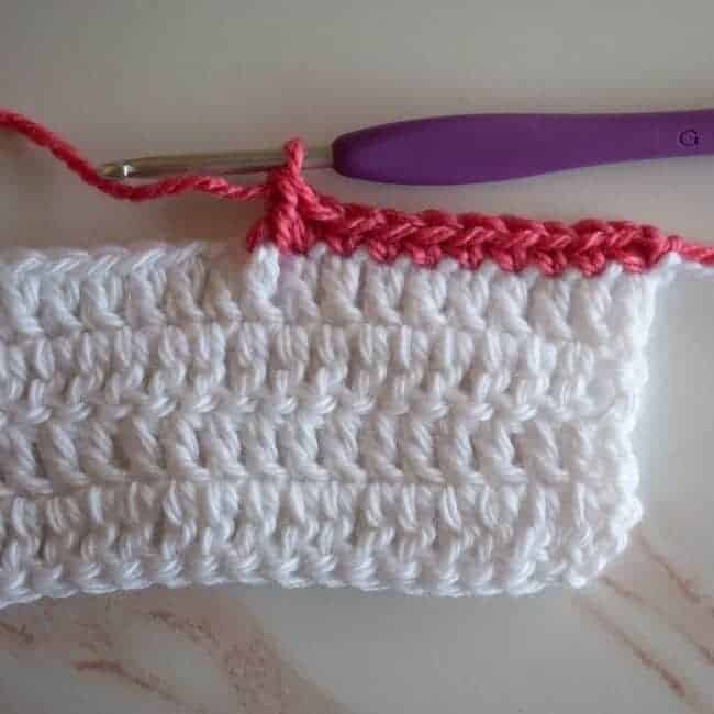 double crochet completed around the post of the indicated stitch below