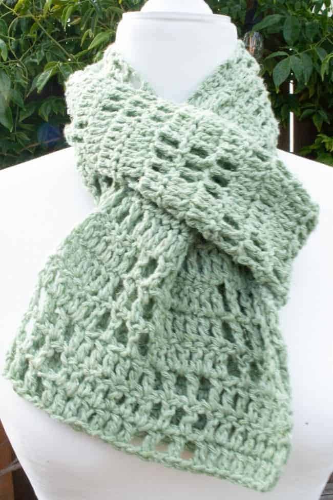 lightweight crochet scarf on a mannequin