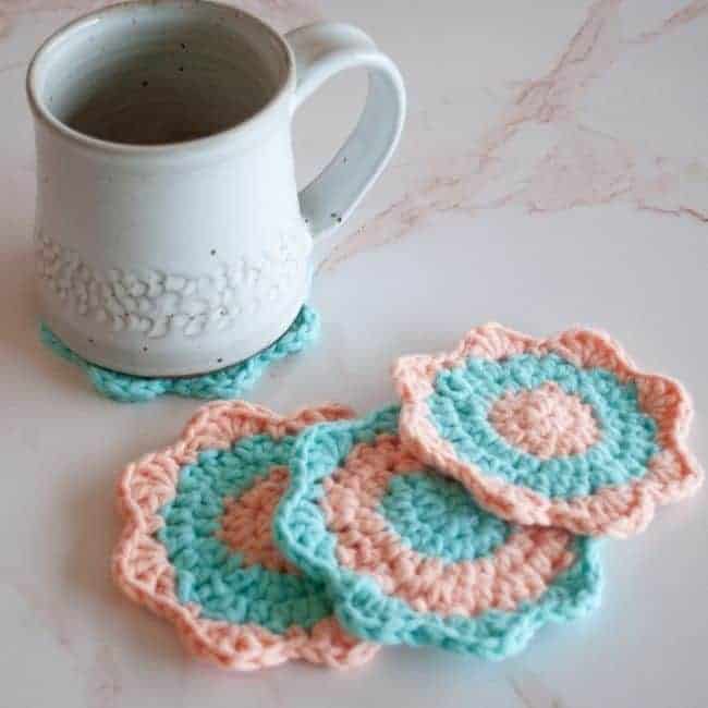 mug on a crochet coaster and three more coasters