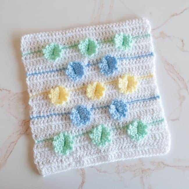 crochet square with flowers on it