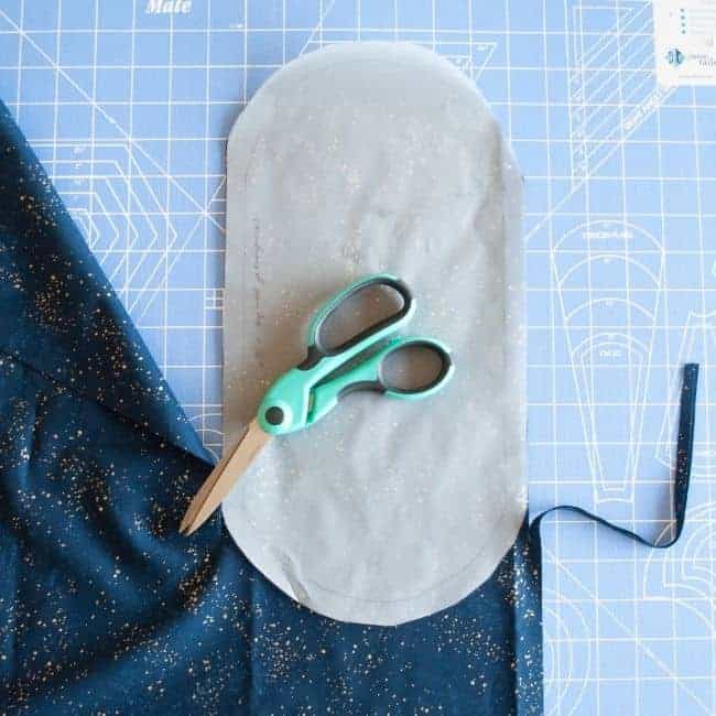 cutting out the bag bottom pieces using scissors