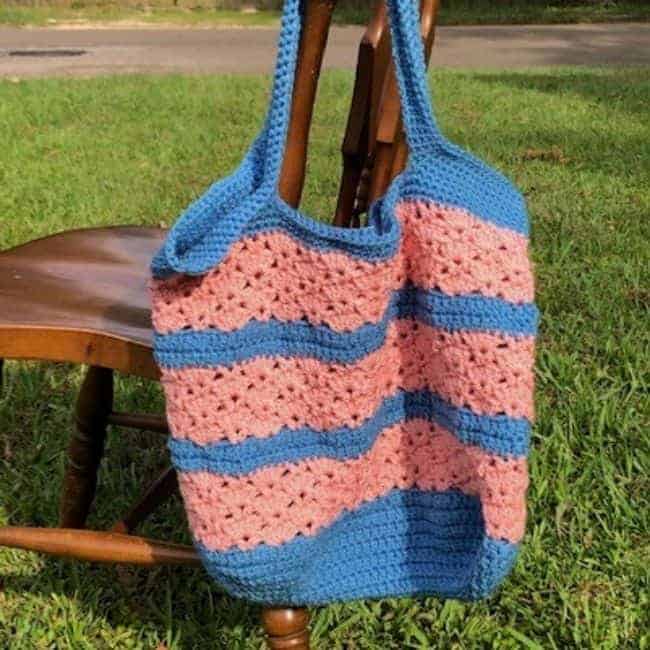 crochet market bag hanging on a chair