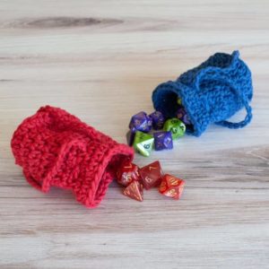 red and blue crochet dice bags with dice spilling out