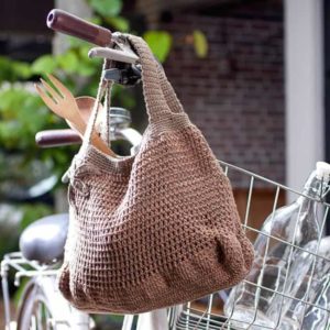 crochet market bag hanging on a bicycle