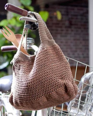 crochet market bag hanging on a bicycle
