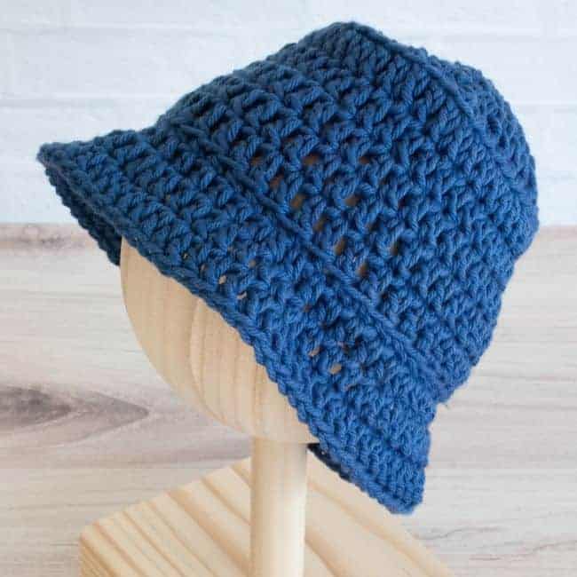 side view blue crochet bucket hat baby size on a mannequin