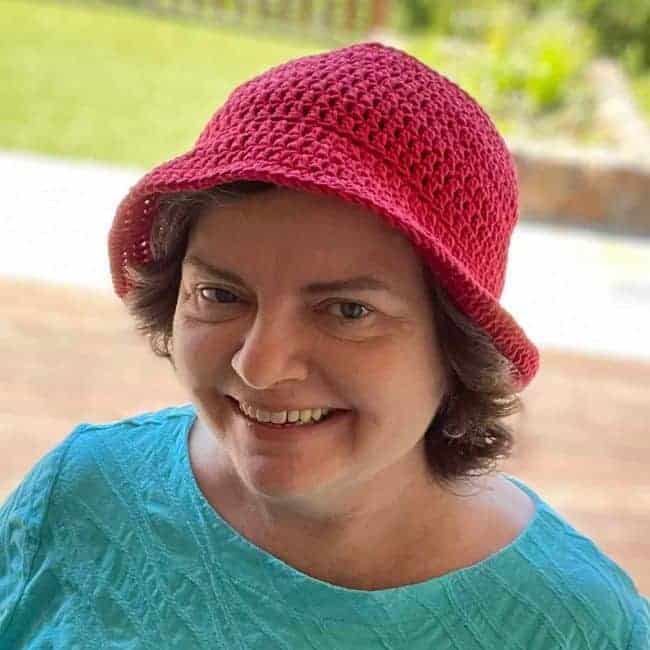 close up of someone wearing red crochet bucket hat