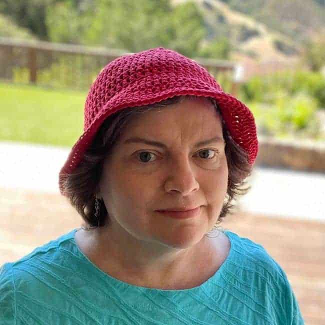 red crochet bucket hat being worn