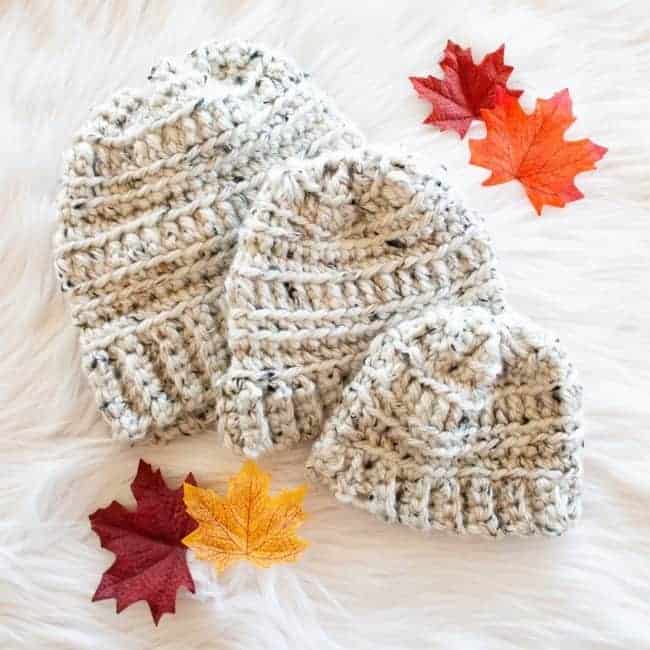 three sizes of super bulky crochet hats and leaves