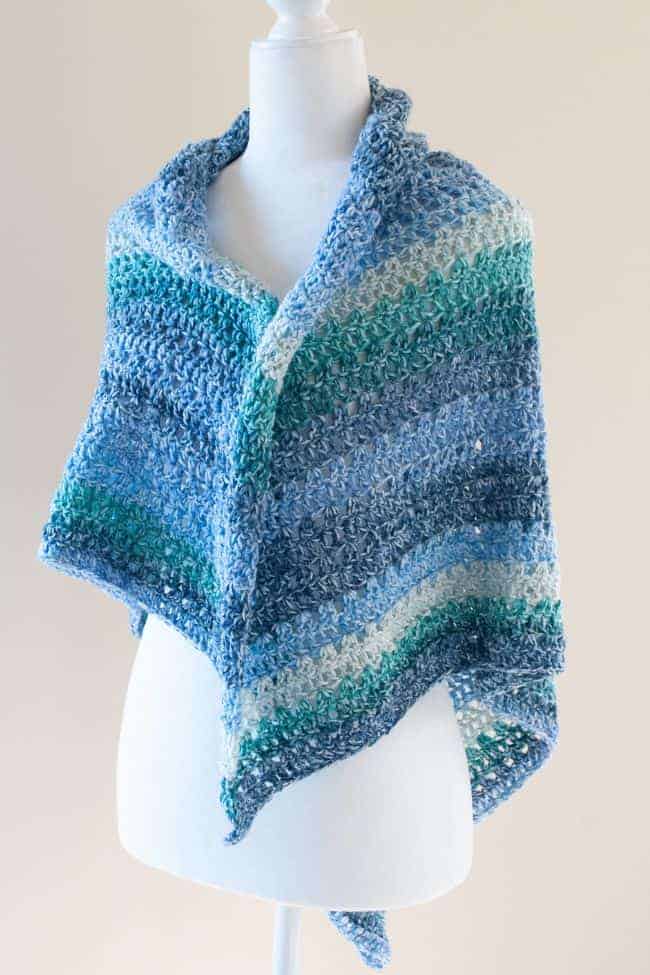 loosely wrapped triangle crochet shawl on a mannequin