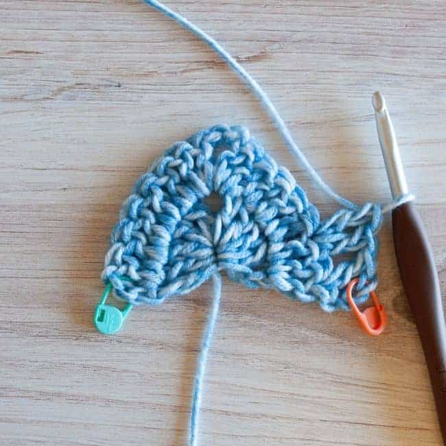 showing skipping a stitch and working two double crochet stitches in the next stitch