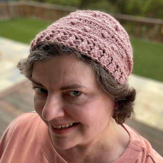 woman wearing light pink crochet beanie