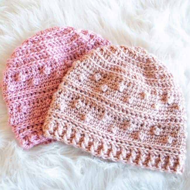 two pink crochet beanies