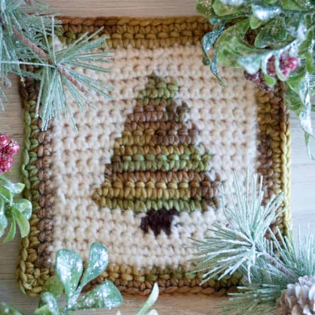 one christmas tree crochet coaster with greenery