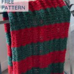 text reading easy crochet christmas blanket free pattern and blanket draped on a quilt rack