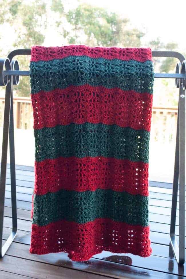 crochet christmas blanket front view on a quilt rack
