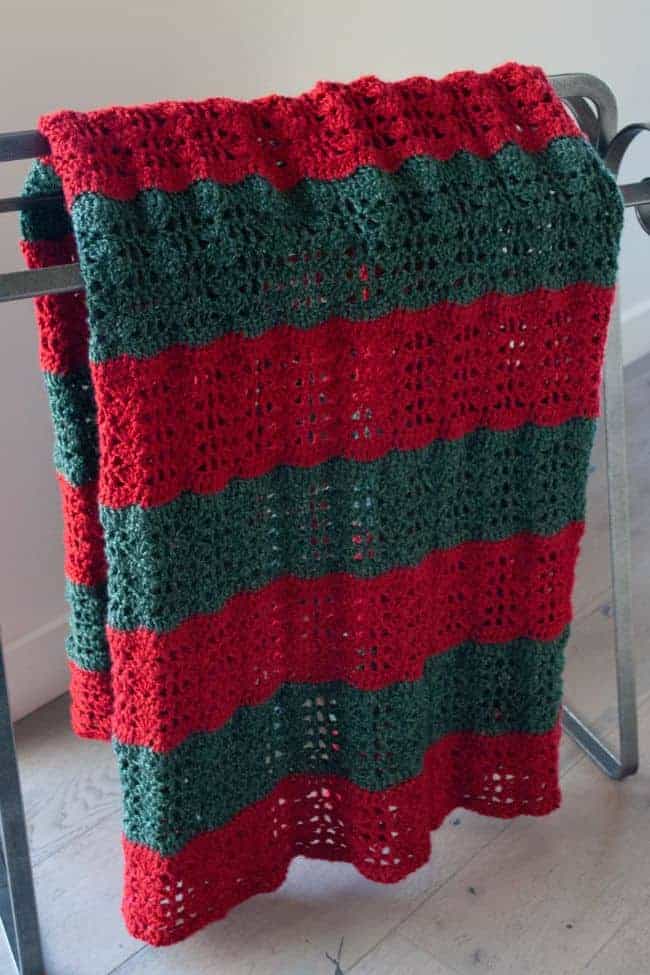 crochet christmas blanket on a quilt rack