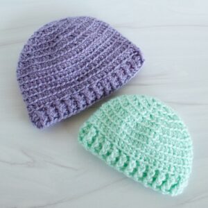 purple and green crochet baby hats
