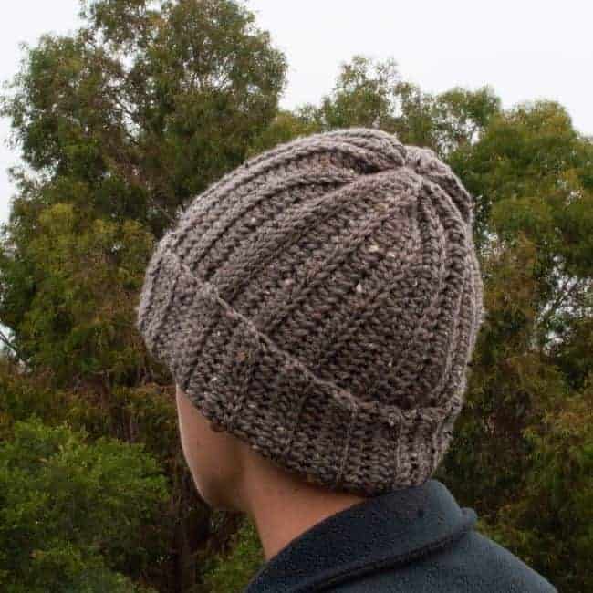side view of man wearing crochet beanie