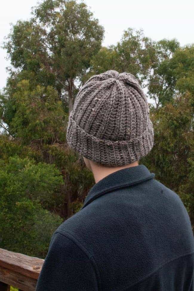 back view of man wearing a brown crochet beanie