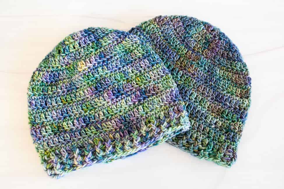 two crochet beanies lying flat side by side