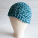 mannequin head with teal crochet hat
