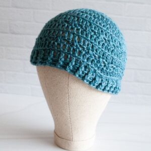 mannequin head with teal crochet hat