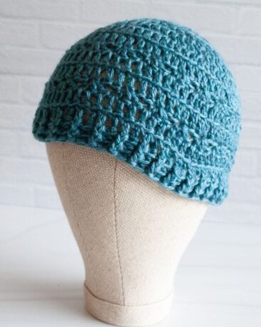 mannequin head with teal crochet hat